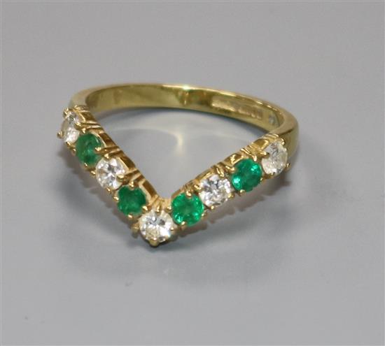 A modern 18ct gold, emerald and diamond wishbone ring, size O.